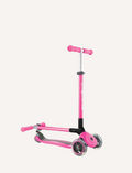 The Globber Primo Foldable Scooter is a blue three-wheeled scooter with a T-shaped handlebar offering adjustable height. It features blue grips, transparent LED-lit wheels, a standing deck, and a rear brake.