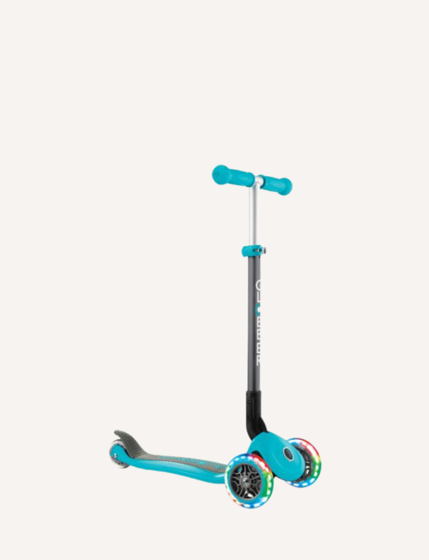 The PRIMO Foldable Lights Scooter - Teal by Globber features a turquoise and black frame, an adjustable handlebar with turquoise grips, and three wheels. The front two wheels are illuminated with colorful lights, and the deck is designed in turquoise with black accents.