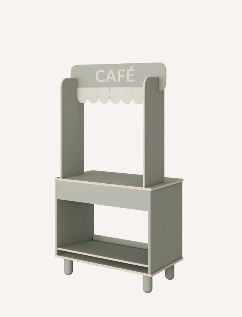 The Flexa Shop and Cafe is a grey play shop adorned with a "SHOP" sign above a charming scalloped awning. It features a counter, shelf, and knobs, measures 113.6 cm in height, 60 cm in width, 36.4 cm in depth, and stands on four short cylindrical legs.