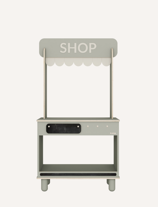 The Flexa Shop and Cafe is a grey play shop adorned with a "SHOP" sign above a charming scalloped awning. It features a counter, shelf, and knobs, measures 113.6 cm in height, 60 cm in width, 36.4 cm in depth, and stands on four short cylindrical legs.