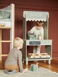 The Flexa Shop and Cafe is a grey play shop adorned with a 