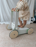 The Moover Toys Classic Baby Walker in green features a minimalistic design with 