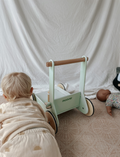 The Moover Toys Classic Baby Walker in green features a minimalistic design with 