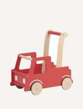 The Moover Push Truck is a red wooden toy car featuring beige wheels and handlebars. It boasts a simplistic design with cut-out windows and a small basket area at the back, marked with the word 