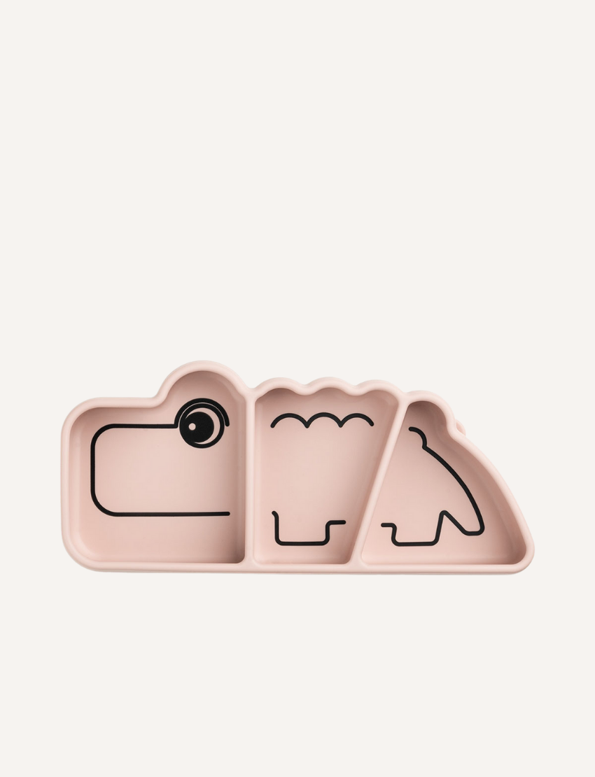 Light pink silicone plate shaped like a crocodile with three divided sections and black line drawings of features.