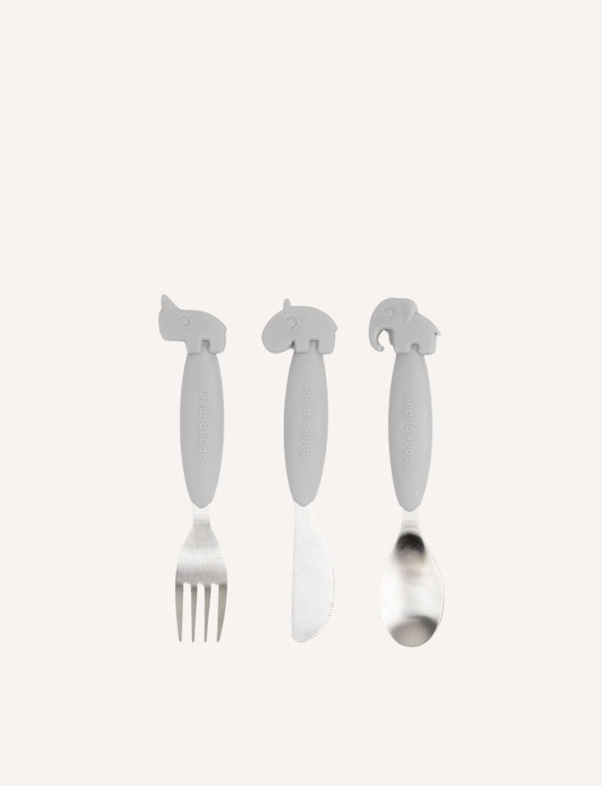 The Easy-Grip Cutlery Set by Done by Deer includes three green toddler utensils, each featuring a silicone handle shaped like an animal head: a fork with a rhinoceros, a knife with a hippopotamus, and a spoon with an elephant. This kids cutlery set is perfect for little hands and makes mealtime fun.