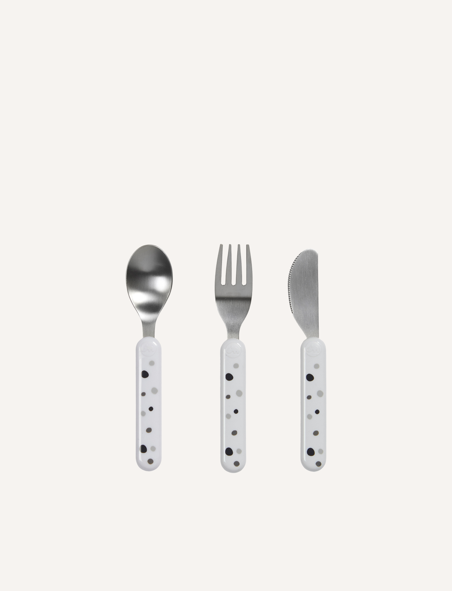 Introducing the Done by Deer Dreamy Dots Cutlery Set - White, perfect for enhancing fine motor skills during mealtime. This set of three utensils includes a spoon, a fork, and a butter knife. Each stainless steel utensil features a white plastic handle adorned with small black dots, neatly arranged on a plain white background.