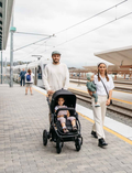 The Bumbleride ERA Pram features a green design, black frame, and brown handlebar. It offers air-filled tires with large rear and smaller front wheels for off-road use. An adjustable seat with a canopy and an under-seat storage basket complete this stroller's convenient features.