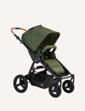 The Bumbleride ERA Pram by Bumbleride is a black baby stroller featuring a canopy and a brown handlebar. It comes equipped with four large wheels and a spacious undercarriage storage basket. The sturdy and adjustable frame makes it suitable for various terrains.