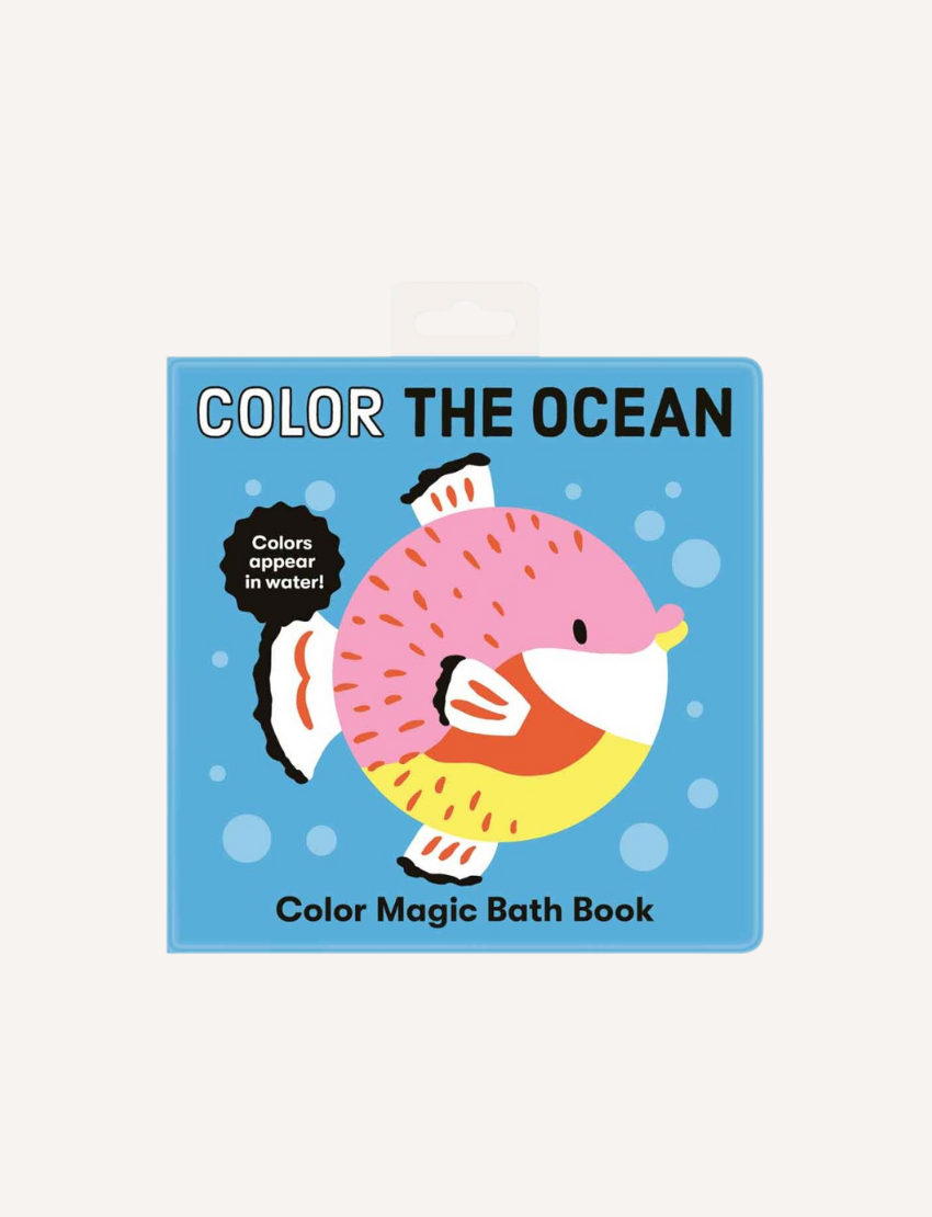 The image shows a children's book titled "Magic Bath Book - The Ocean" by Mudpuppy with the caption "Colors appear in water!" The blue cover features an illustrated fish with pink, yellow, white, and orange hues surrounded by bubbles. Experience bath time fun with color-changing pages!