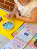 A DIY craft kit from Tiger Tribe is displayed, including a Rainbow Lab - Playing with Colour booklet titled 