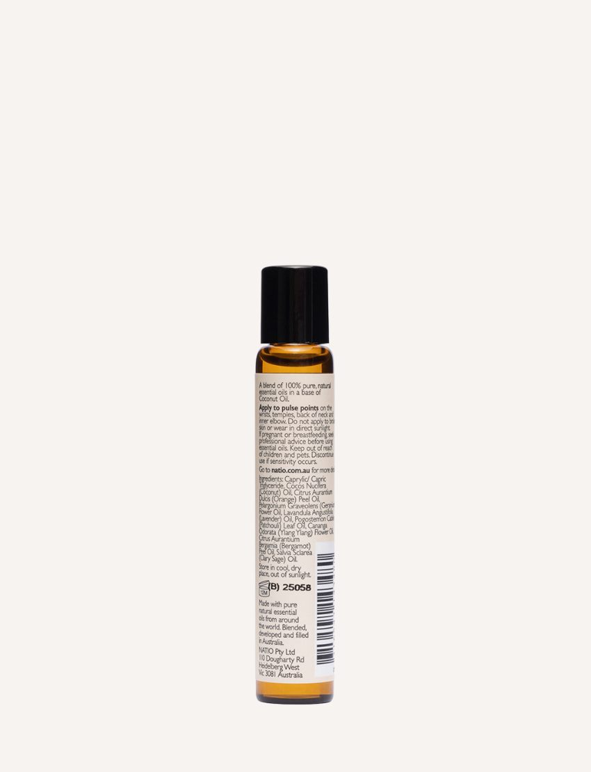 A small, cylindrical amber bottle with a black cap from Natio, labeled "Focus on Essential Oil Roll-On." The bottle features a roll-on applicator and text in English detailing the ingredients, usage instructions for skin nourishing benefits, and regulatory information.