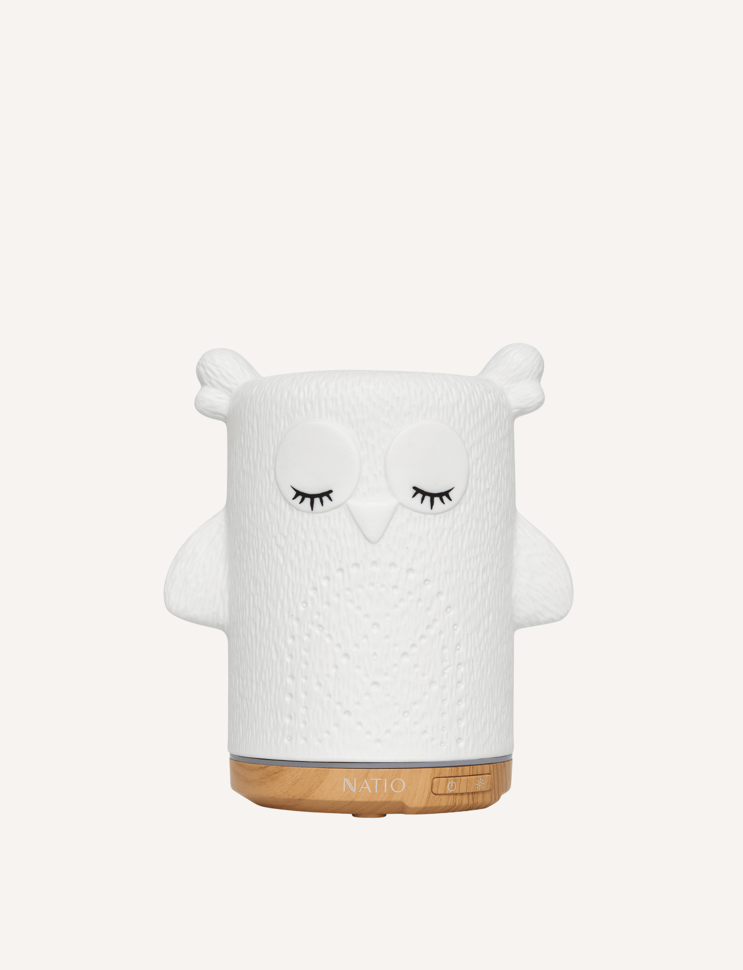 White ceramic owl ultrasonic essential oil diffuser with wood base.