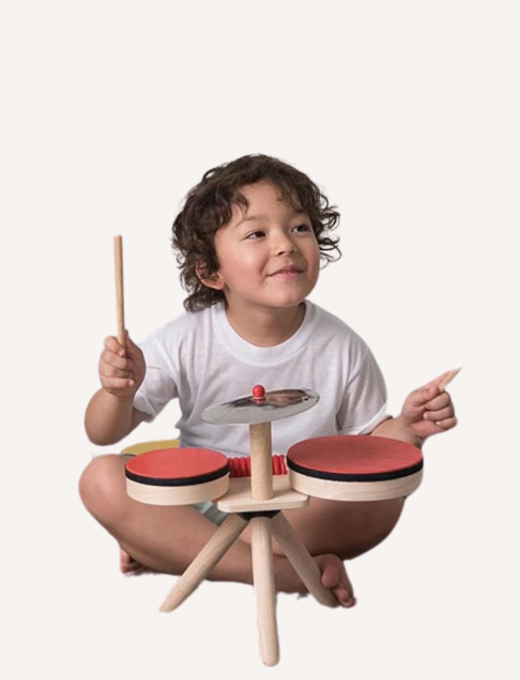 The PlanToys Musical Band is a small wooden drum set with three legs, perfect as a toddlers' musical toy. It includes two red drums, a metallic cymbal with a red bead on top, and two wooden drumsticks. The overall design is simple, minimalist, and eco-friendly.