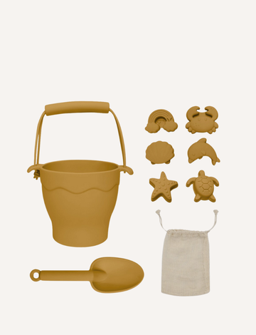 Playground's 8-Piece Bucket & Spade Set, featuring a yellow bucket with a handle, a small shovel, five sand molds in various shapes (sun, cloud, starfish, turtle, and crab), and a drawstring storage bag—all neatly arranged on a plain background.