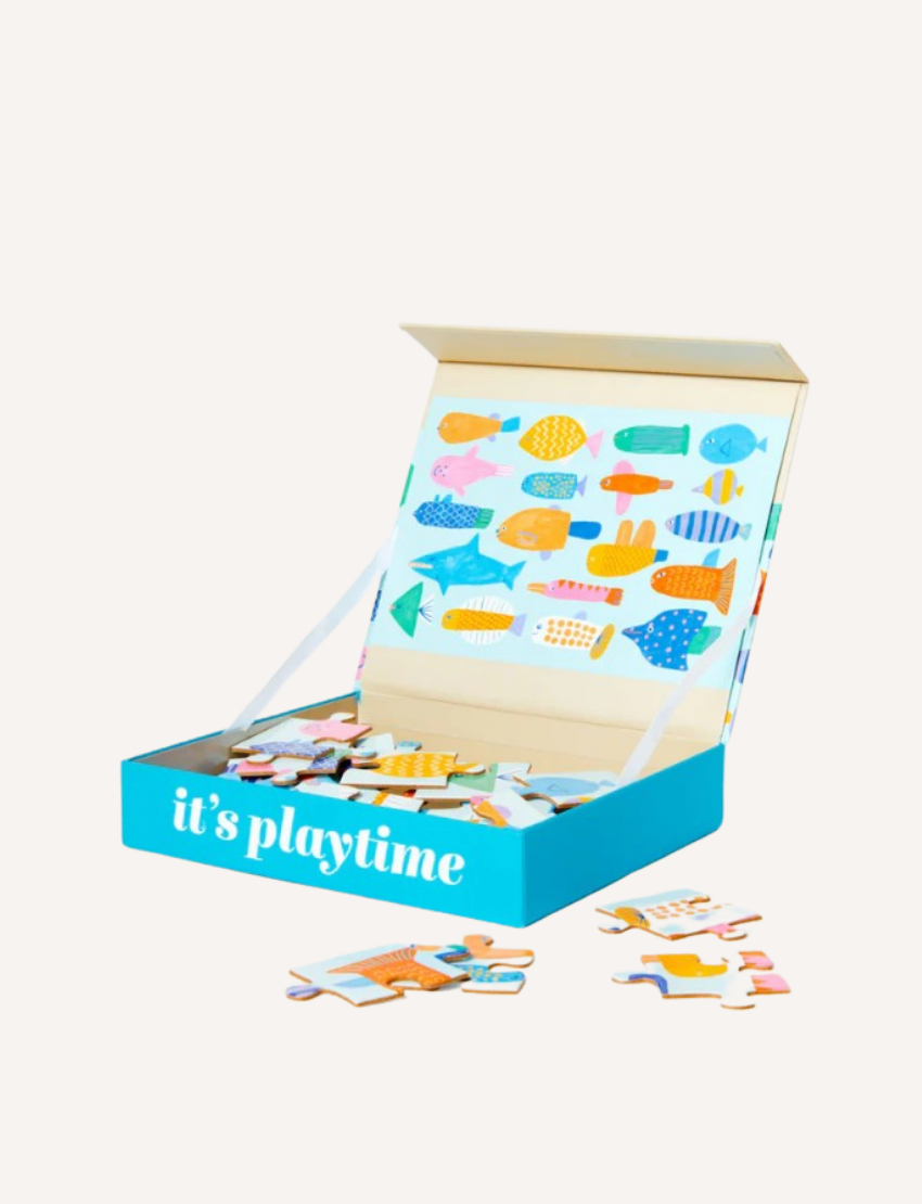 A green box labeled "it's playtime" contains a colorful elephant-themed wooden jigsaw puzzle from Journey of Something's 24-Piece Kids Puzzle collection. The box is open, displaying the completed puzzle image inside the lid, with several pieces scattered outside—a perfect creative children's activity.