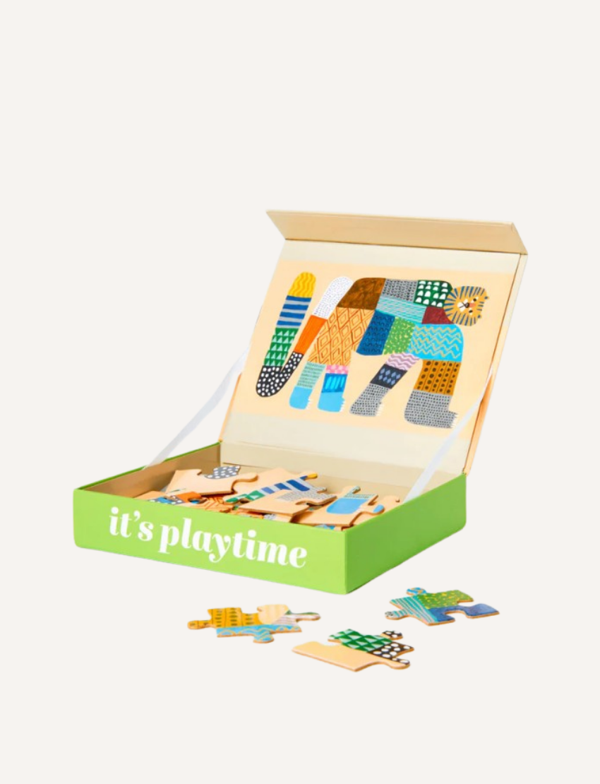 A green box labeled "it's playtime" contains a colorful elephant-themed wooden jigsaw puzzle from Journey of Something's 24-Piece Kids Puzzle collection. The box is open, displaying the completed puzzle image inside the lid, with several pieces scattered outside—a perfect creative children's activity.