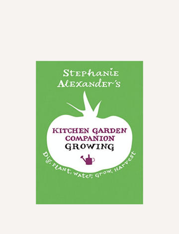 The image displays the cover of a book titled "Kitchen Garden Companion: Growing" by The Play Way. The green cover showcases a white silhouette of a tomato with the title inside. Below, it reads "Dig, Plant, Water, Grow, Harvest" accompanied by a small purple watering can icon—ideal for kitchen gardening enthusiasts!