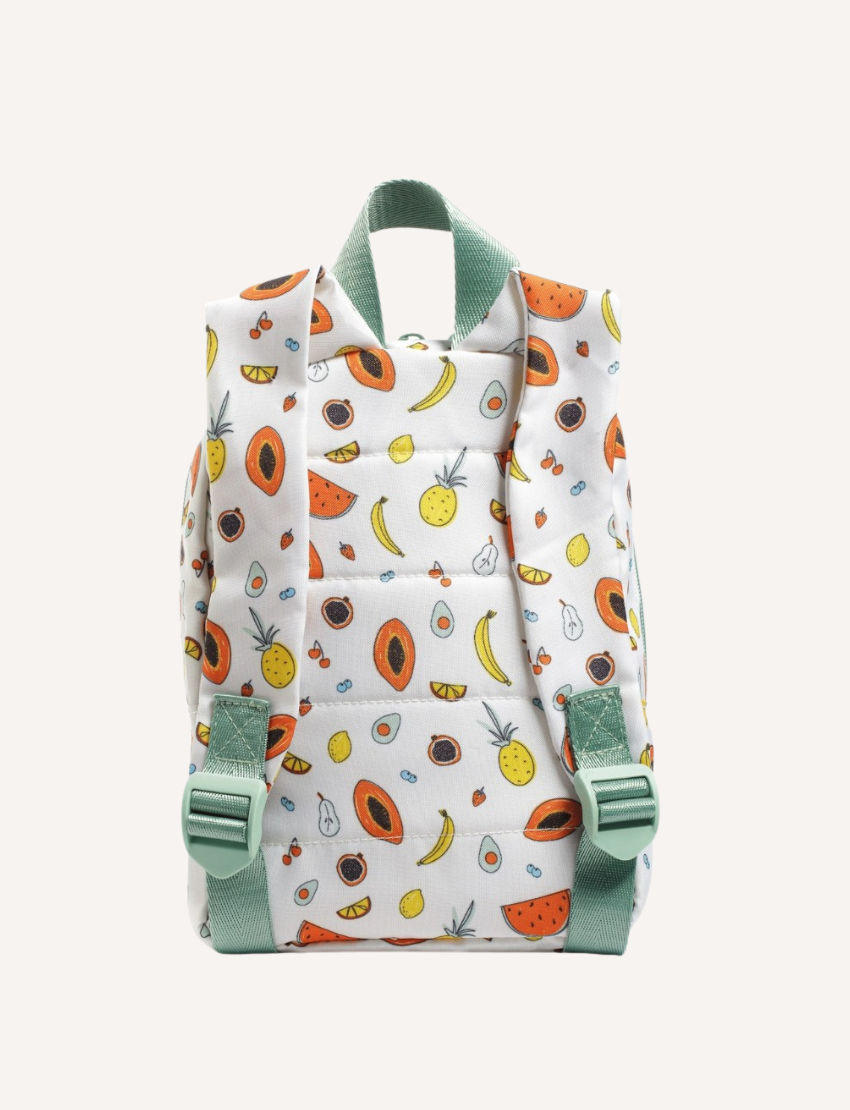 The IZIMINI Mini Backpack, featuring a cream-colored base adorned with a playful fruit pattern—including avocados, bananas, pineapples, and watermelons—is perfect for your toddler. It boasts mint-green straps and zipper pulls, a small exterior pocket, and plenty of space for little essentials.