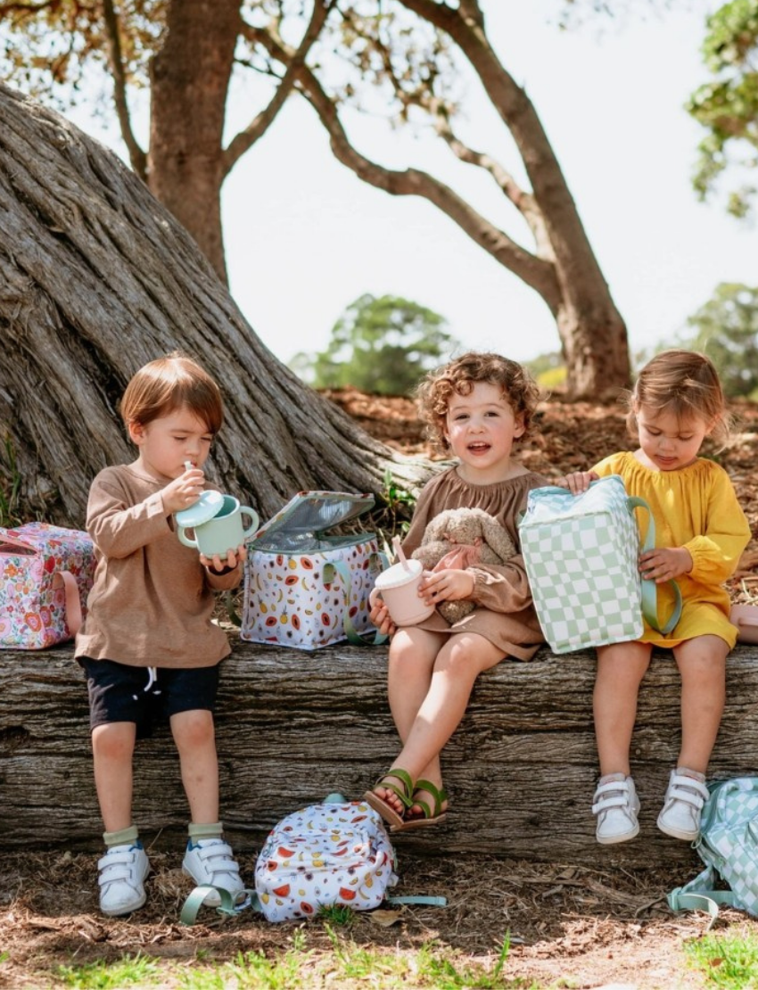 The IZIMINI Mini Backpack features a light sea-themed pattern with seashells, starfish, and leaves, perfect for your little explorer. It includes a front zipper pocket and turquoise handles.