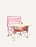 The IZIMINI Baby Chair is a lightweight and portable option, featuring a pink and white checkered fabric seat and a beige tray. It boasts a durable frame made of white plastic and metal, with secure, wide-set feet for enhanced stability.