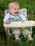 The IZIMINI Baby Chair is a lightweight and portable option, featuring a pink and white checkered fabric seat and a beige tray. It boasts a durable frame made of white plastic and metal, with secure, wide-set feet for enhanced stability.