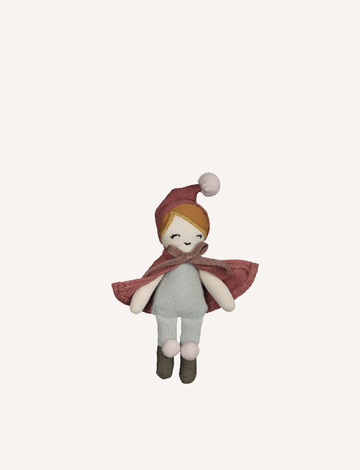 The Christmas Pocket Friend by Fabelab is a small fabric doll, perfect as a Pocket Friend or travel companion. It features a pink hat, brown body, white legs, brown boots, and short light brown hair with minimalistic stitched facial features and a neutral expression. The doll is displayed against a plain white background.