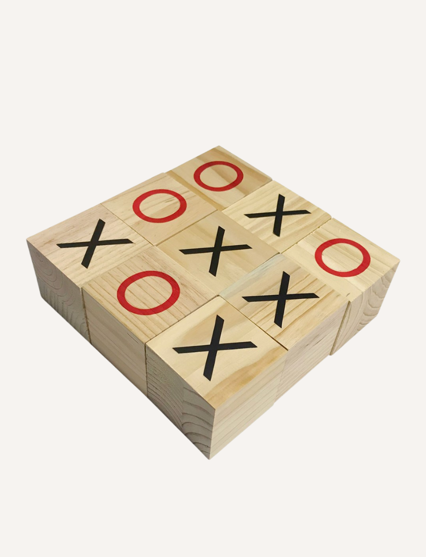 The Formula Sports and Games Tic Tac Toe box packaging displays an image of two people playing the game outside using large wooden blocks. It emphasizes that the set includes 9 high-quality wooden pieces, each measuring 7x7x7 cm, along with the game rules.