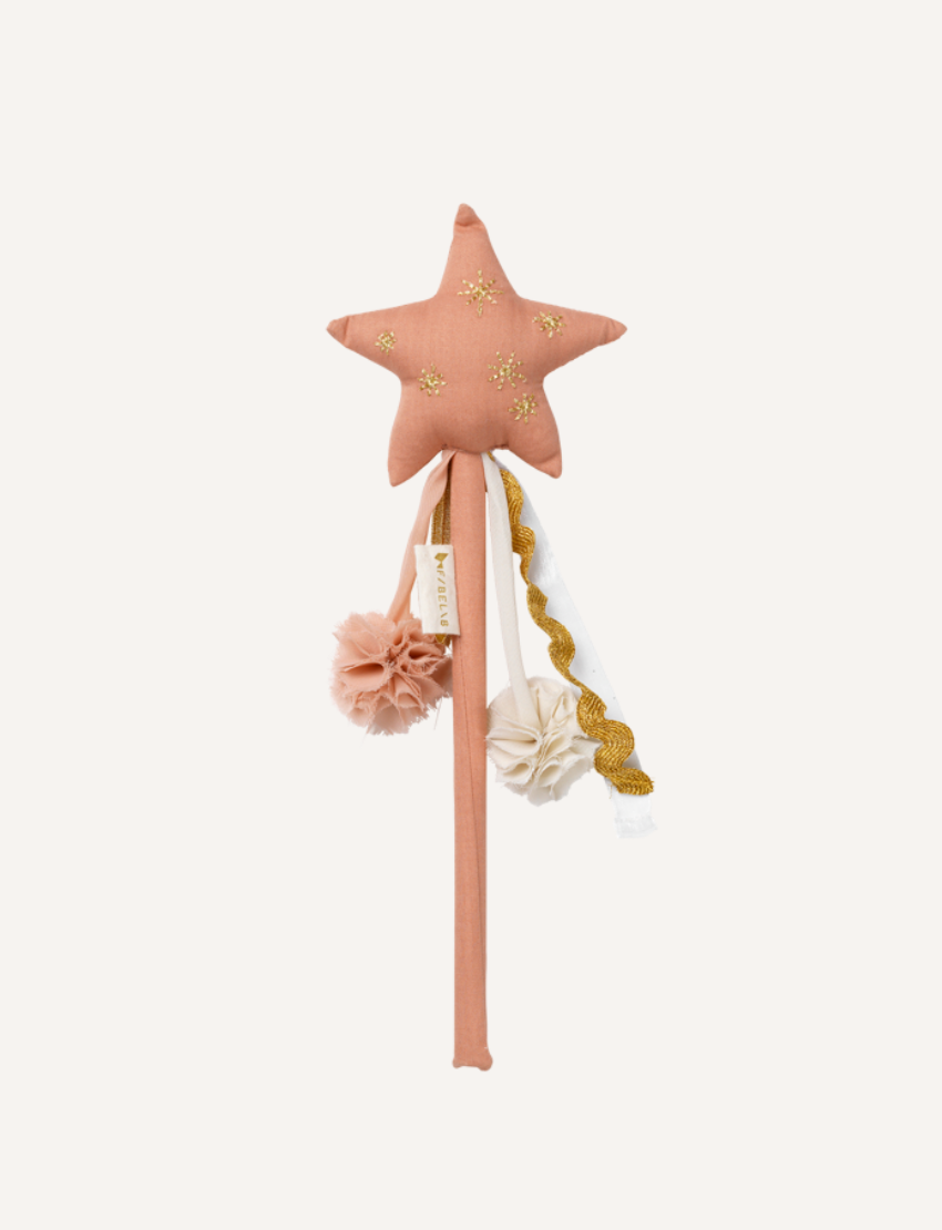 The Fabelab Fairy Wand is crafted from organic cotton with a star-shaped design and fabric handle. Adorned with gold star embroidery, it features two pom-poms and yellow/gold ribbon streamers, perfect for imaginative play against a plain white background.