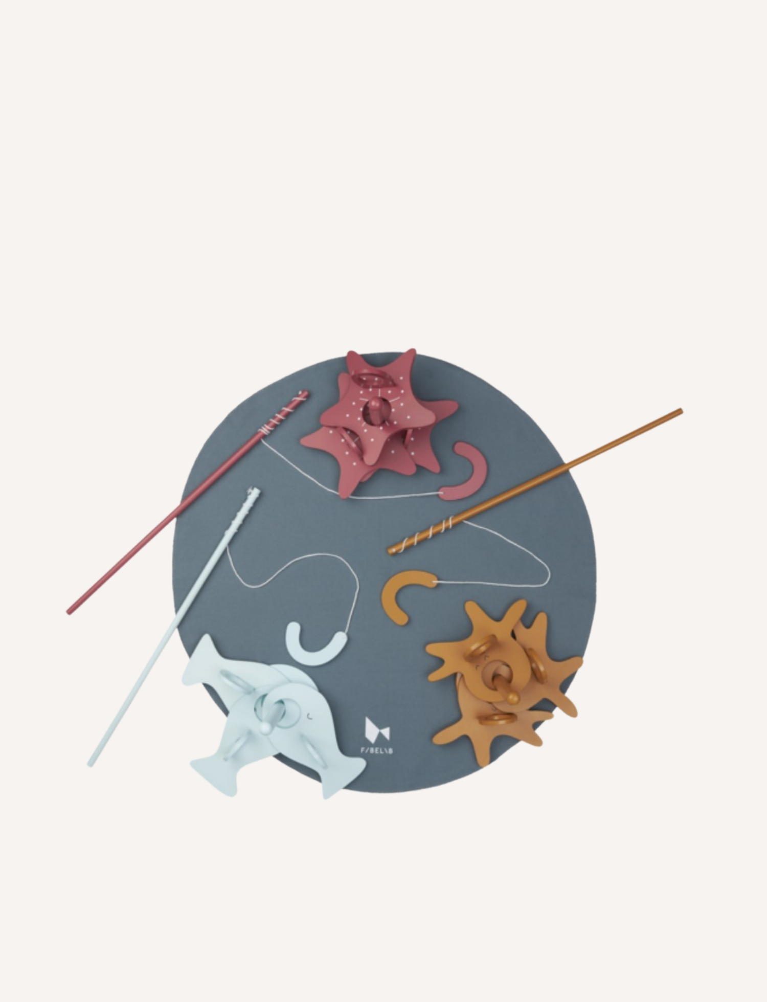 Overview of a wooden magnetic fishing game set on a dark blue play mat, featuring fish and stars.