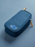 The Fabelab Eco Pencil Case is a stylish blue, rectangular zippered pouch crafted from recycled polyester, featuring a simple line drawing of a hand making a peace sign in blue and white on the upper left corner.