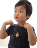 Child playing with Acorn Spinning Top 