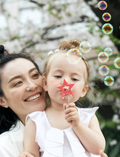 The image displays the Amechan Magical Bubble Wands by kiko+ and gg*, featuring three wooden wands and one wooden dish, ideal for eco-friendly bubble fun. The wands have star-shaped tops in red, yellow, and blue, with handles engraved 