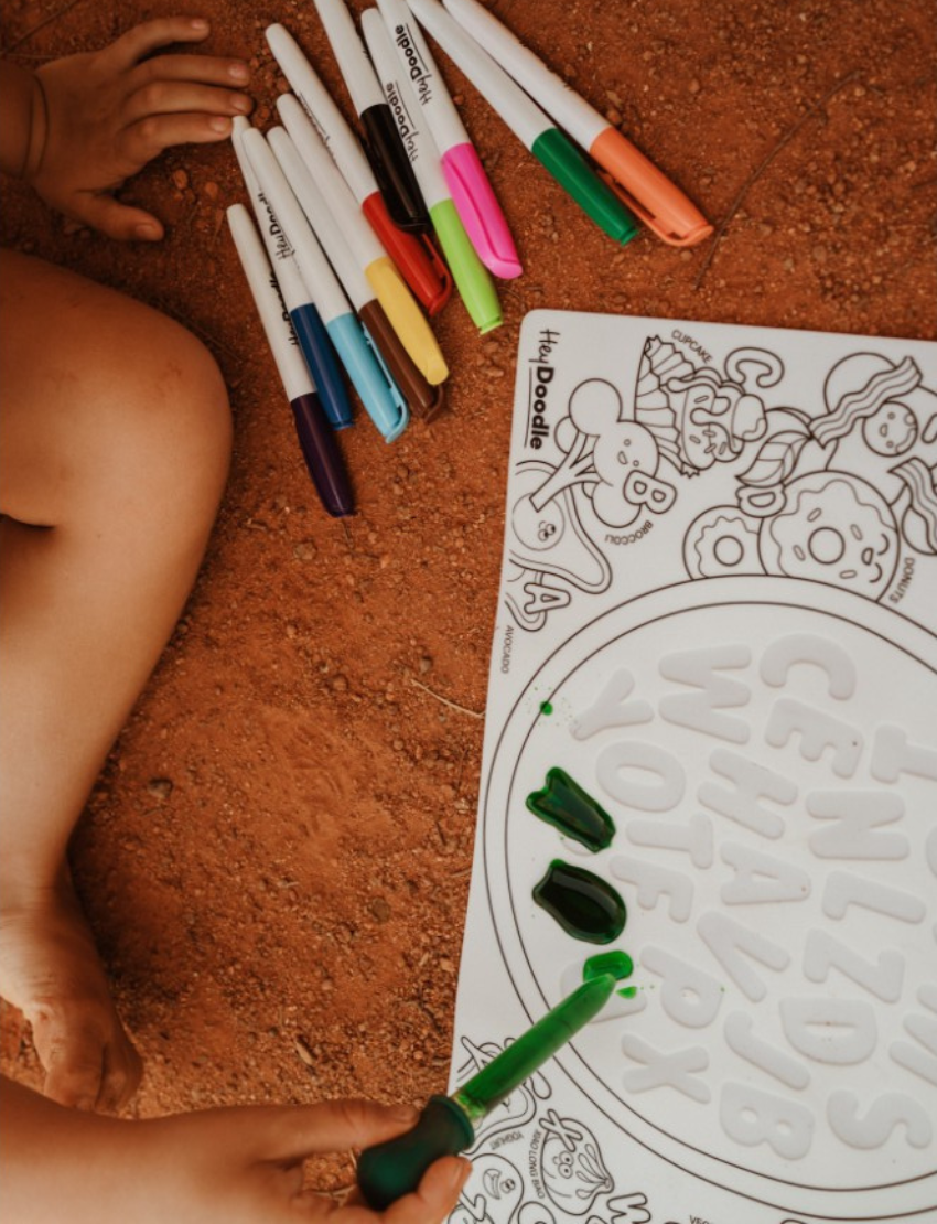 The HeyDoodle Sensory Mat by HeyDoodle provides an engaging coloring experience with black and white insects, perfect for enhancing sensory play and fine motor skills. It comes with vibrant markers to boost interactive learning.