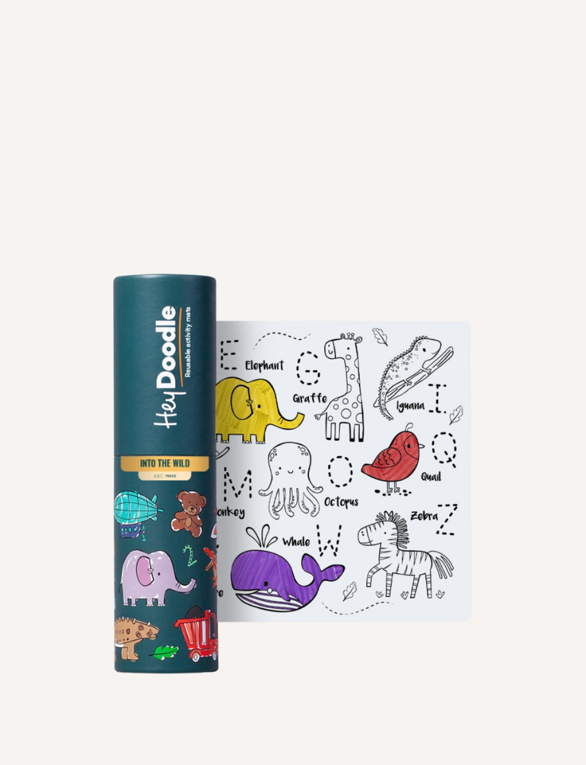 A cylindrical container labeled "HeyDoodle Mini Mat - ABC - Into The Wild" is next to a reusable drawing mat. The silicone mats feature illustrated animals like a whale, zebra, octopus, and giraffe, each paired with alphabet letters corresponding to their names.