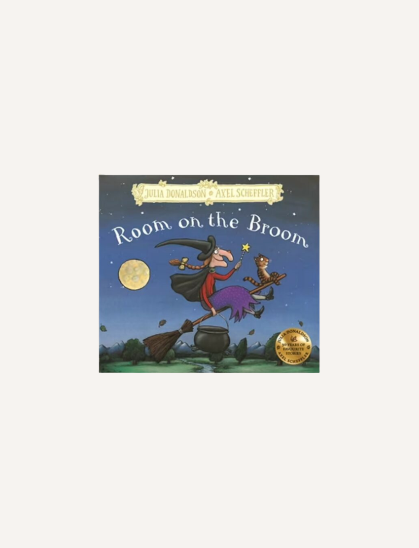 The cover of "Room on the Broom" by Julia Donaldson and Axel Scheffler depicts a witch, accompanied by a cat, dog, bird, and frog, all soaring on a broomstick beneath a full moon. The witch is shown holding a wand while various objects float in the sky.