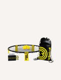 Image of the Spikeball Kit - Original by Spikeball, featuring a yellow and black drawstring bag with the Spikeball logo, two yellow balls also branded with the logo, a folded circular net frame, netting, a rulebook, and a Spikeball box in the background.