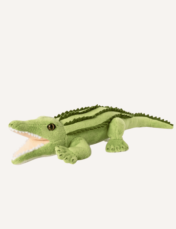 Image of the Living Nature Crocodile soft toy by Living Nature, designed as a green crocodile with an open mouth revealing white teeth. Made from recycled plastics, the toy showcases textured ridges along its back, a long tail, and four short legs. The eyes are black and realistic. The background is plain white.