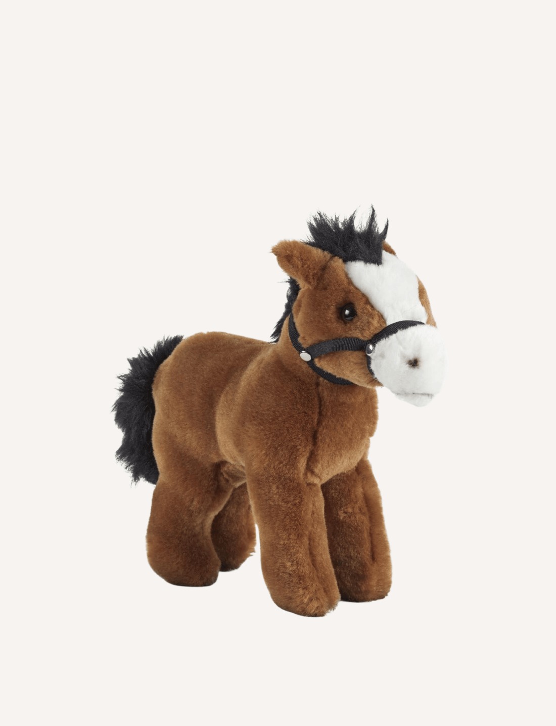 The Living Nature Horse from Living Nature stands against a plain white background. This premium horse soft toy features a brown body, black mane and tail, and a white snout, accented with a tiny black halter. Made from 100% post-consumer recycled plastics, this plush toy is not only adorable but eco-friendly too.