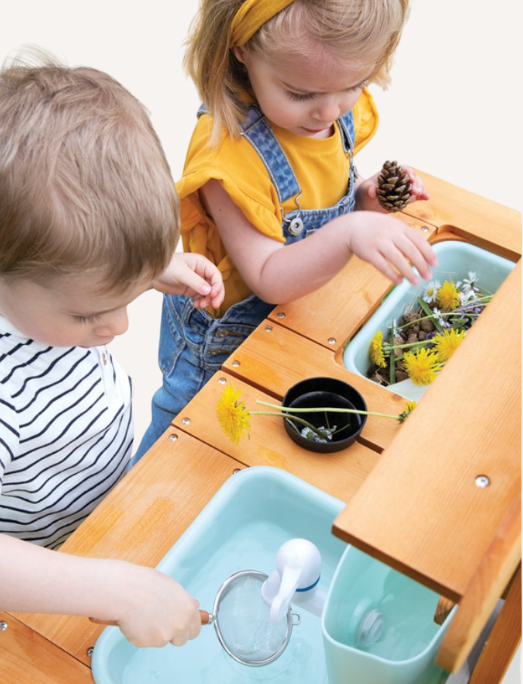 Janod's "Muddy Lab Outdoor Kitchen" is a boxed toy set that includes an outdoor wooden kitchen crafted from FSC certified wood. It features shelves, hooks for utensils, and an attached water dispenser. The packaging displays images of the assembled product alongside children joyfully playing with the Muddy Lab Outdoor Kitchen.