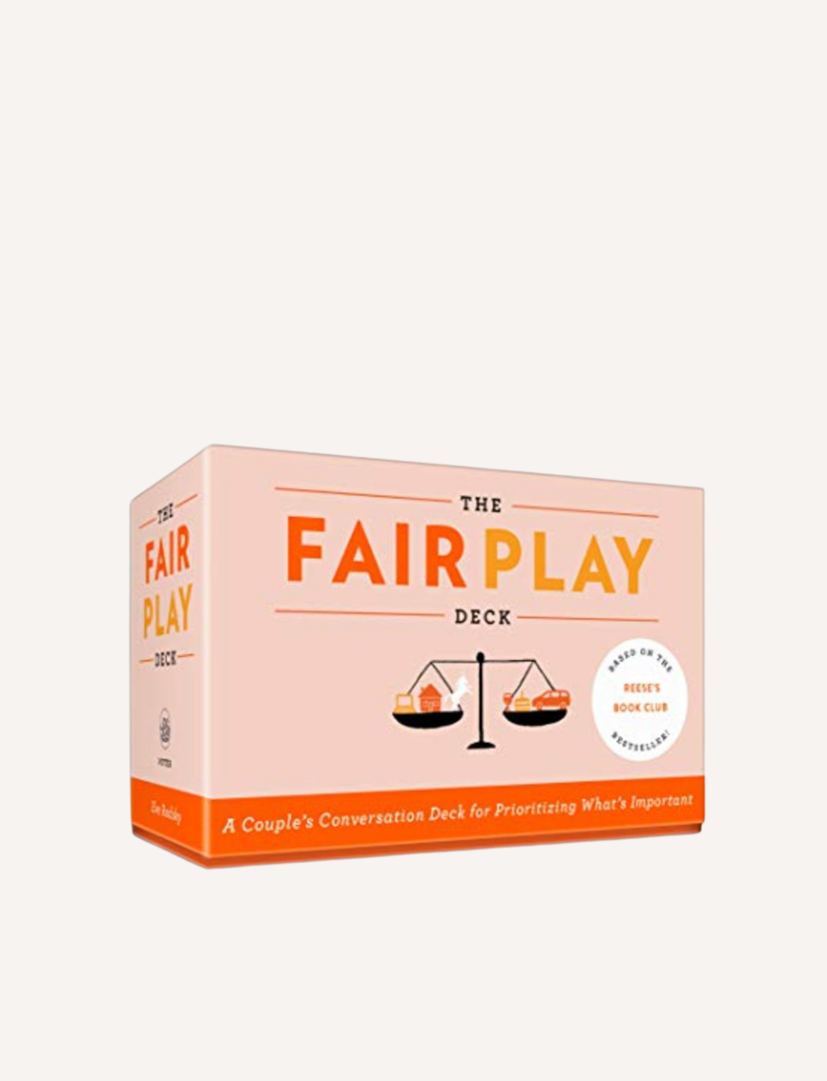 A rectangular box of "Fair Play Card Deck" from The Play Way is shown. The pink box features illustrations of scales and a tagline reading, "A Couple's Conversation Deck for Prioritizing What's Important." This deck aims to bring household balance, making time for everyone’s Unicorn Space.