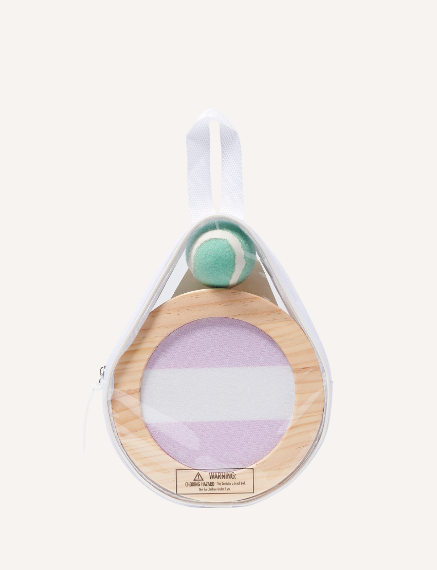 The Catch Ball Set - Rio Sun Multi by Sunnylife includes two round wooden paddles adorned with blue and lavender stripes, elegantly set against a light backdrop. A small green and white tennis ball floats above, inviting play.