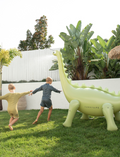 The Giant Snake Sprinkler by Sunnylife, with its yellow and white striped inflatable design, googly eyes, and orange tongue, brings fun to the backyard. Crafted from durable PVC, its long, wavy body has two rounded bases for stability.