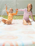 Image of the Sunnylife Slip, Slide and Body Board Set - Tie Dye Multi, showcasing a light pastel tie-dye pattern featuring swirls of pink, blue, and yellow. Two small inflatable pool rings with matching patterns are positioned next to the slide against a plain white background.