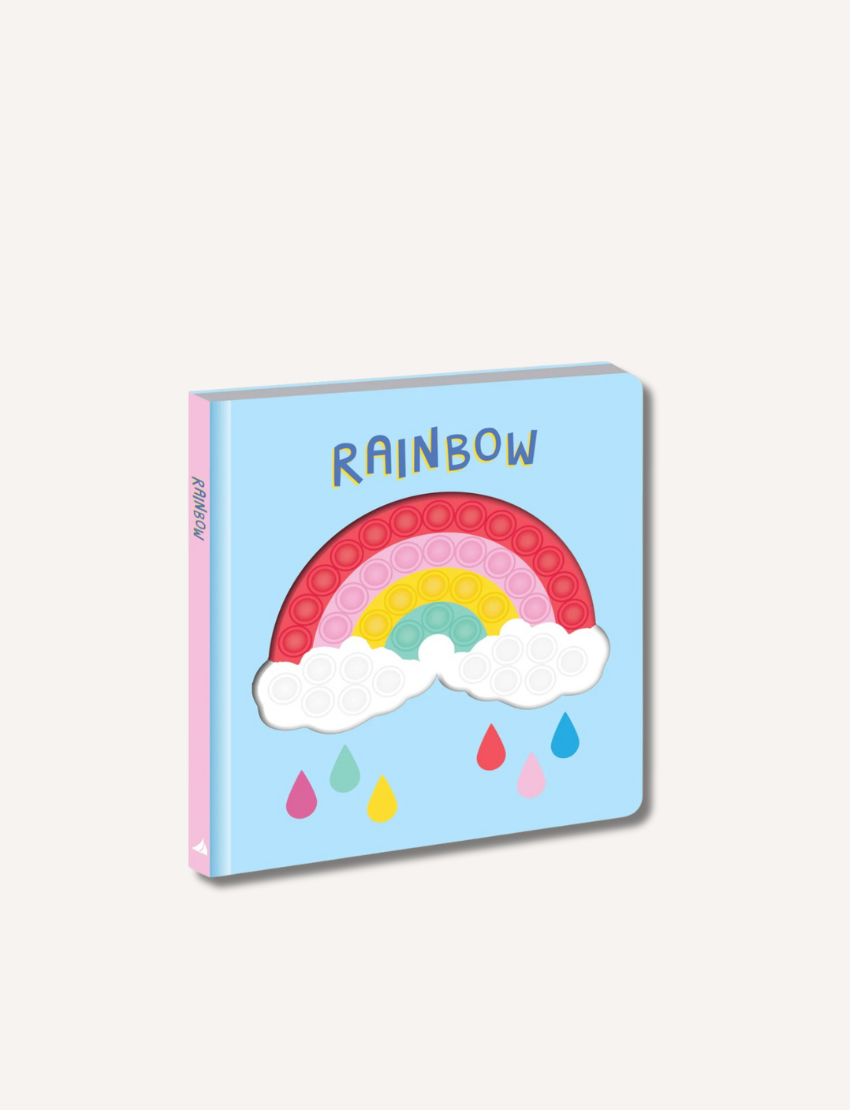 The image shows the "Bubble Pops Book - Rainbow" by Lake Press, a children's book with a light blue cover and a pink spine. The cover features a rainbow with pop-it bubbles, white clouds, and colorful raindrops. The word "RAINBOW" is printed above the rainbow, making it the perfect rainbow book for young readers.