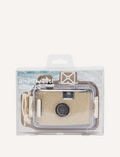 The Underwater Camera - Glitter Gold by Sunnylife floats on clear, shallow water. The sun creates rippling light patterns on the water's surface. A white cord is attached to the camera, trailing in the water.