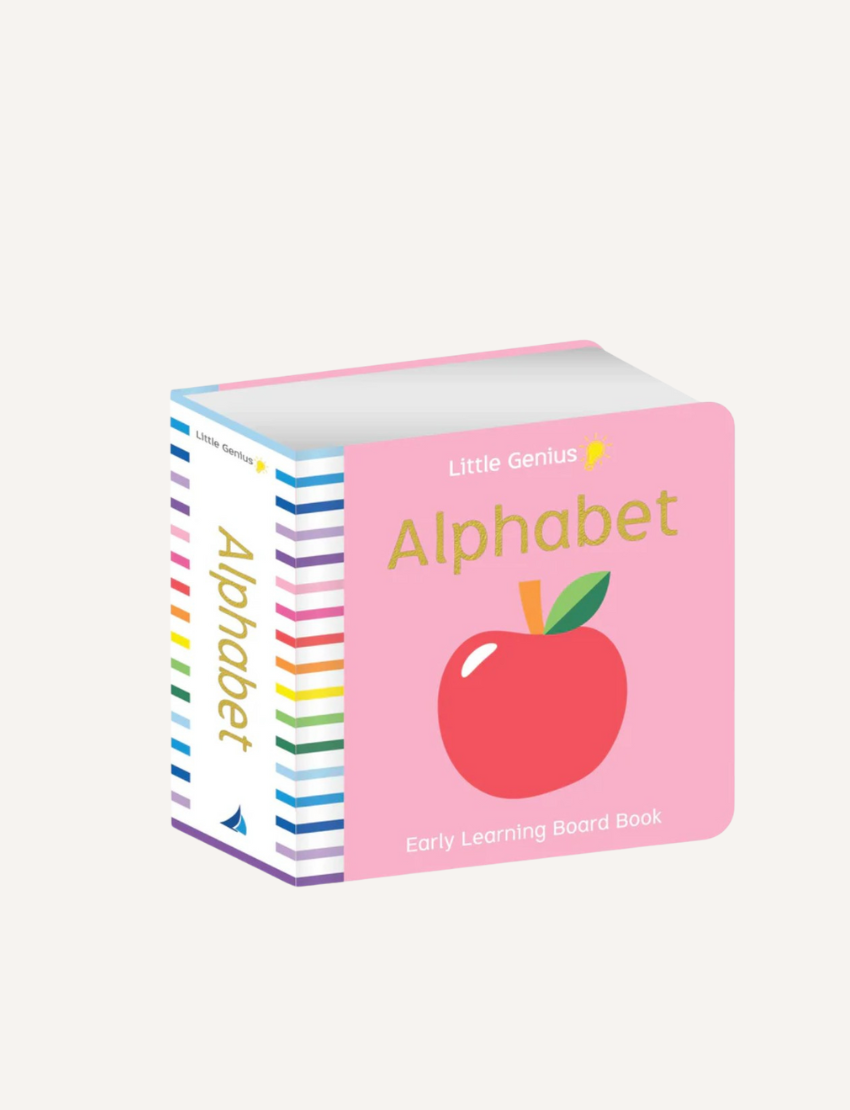 A children's board book titled "Little Genius Vol. 2 - Chunky Board Alphabet Book" by Lake Press is shown. The book has a pink cover featuring a red apple illustration and the text "Early Learning Board Book." With vibrant illustrations, the spine displays rainbow-colored stripes along with the title "Alphabet.