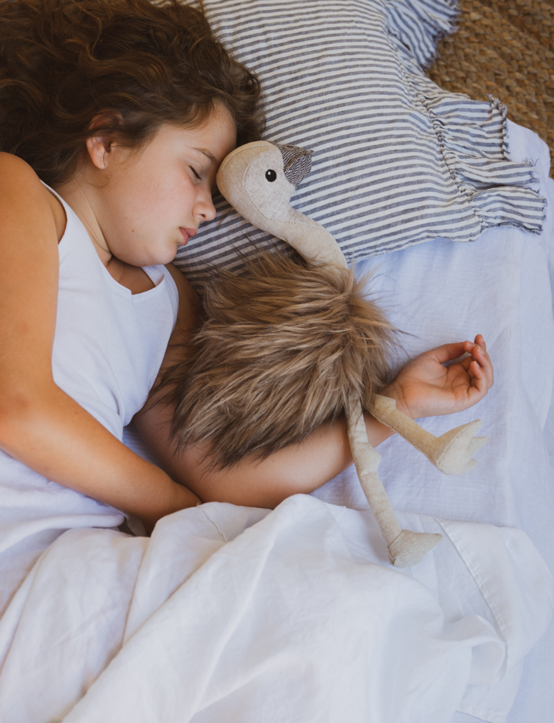 A plush ostrich toy named Eddie the Emu from Nana Hutchy features a beige body and head, dark round eyes, and fluffy brown feathers. The soft toy is posed sitting with its legs stretched out in front, ready for the Australian Animal Olympics as Eddie's charming companion.