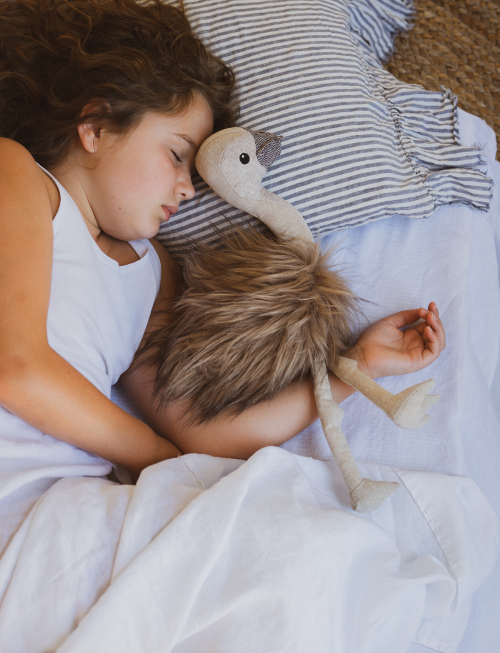 A plush ostrich toy named Eddie the Emu from Nana Hutchy features a beige body and head, dark round eyes, and fluffy brown feathers. The soft toy is posed sitting with its legs stretched out in front, ready for the Australian Animal Olympics as Eddie's charming companion.