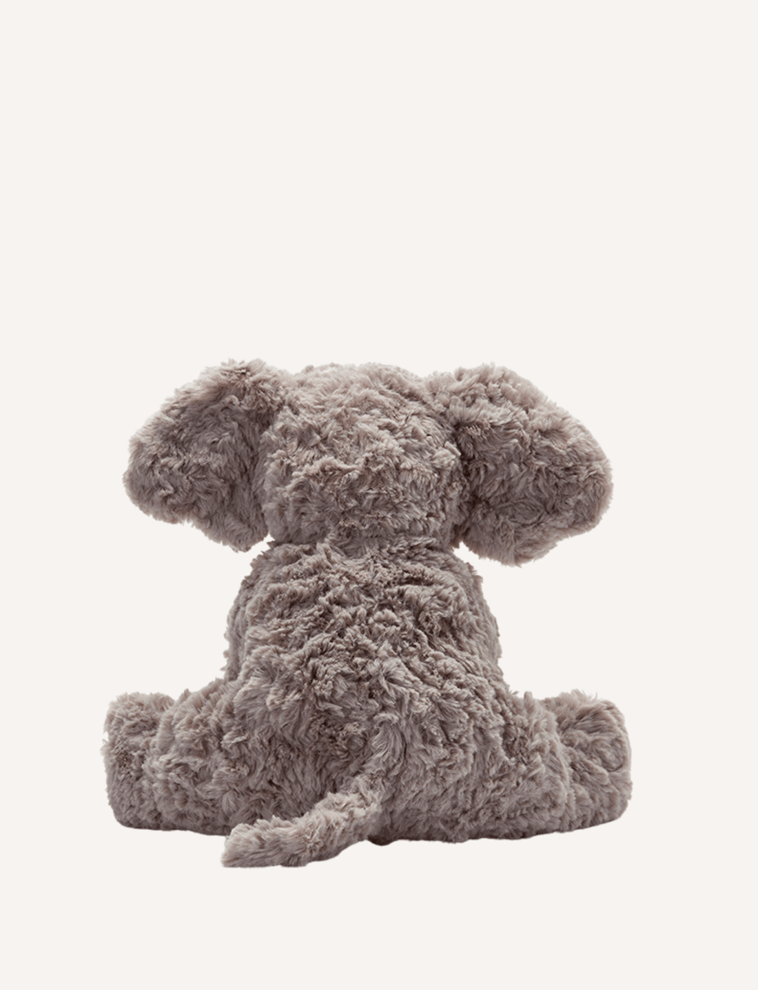 Jimmy the Elephant from Nana Hutchy is pictured against a plain white background. This plush gray elephant toy features a soft body, endearing large floppy ears, a long trunk, and white tusks. Sitting with its trunk slightly curled, this adorable toy captures hearts effortlessly.